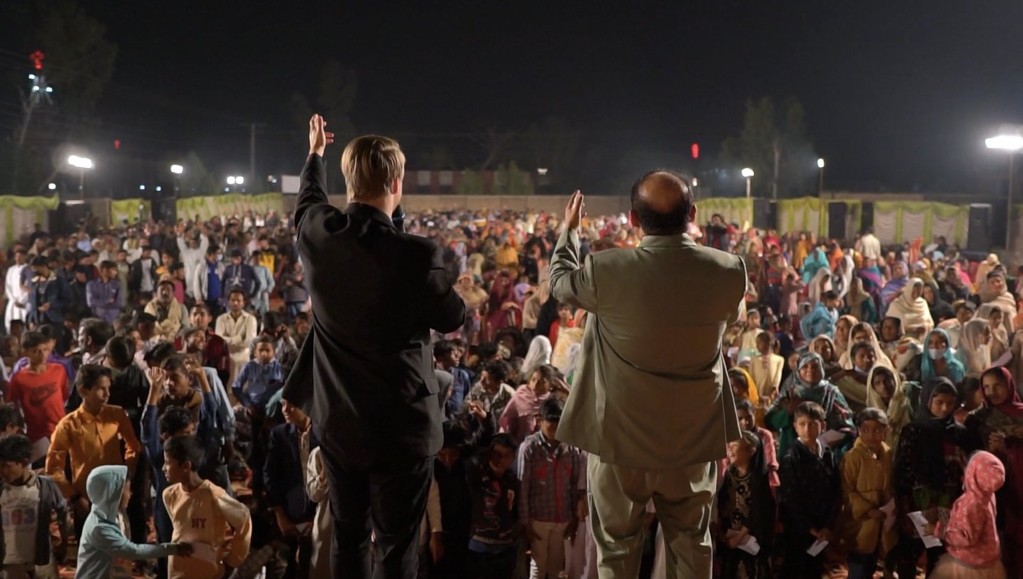 An evangelist speaking to a crusade crowd